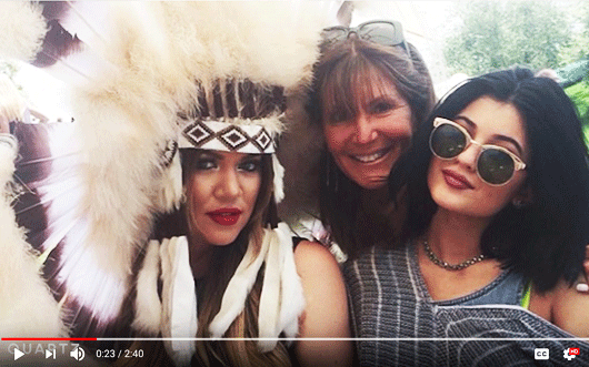 White woman, posing with friends, wearing a native american headress